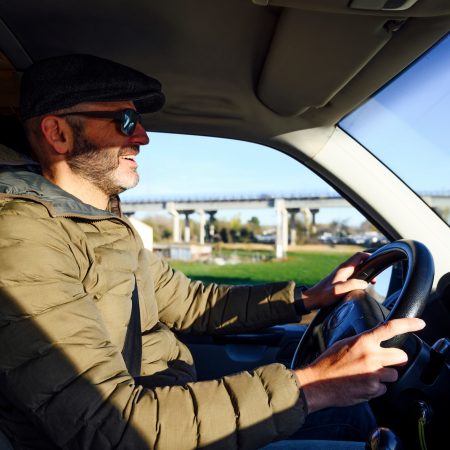 Cheerful man driving a car