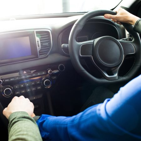 Cropped image of couple test driving